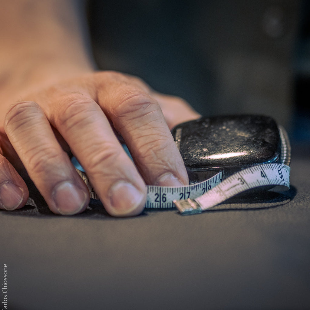 Hand holding a measuring tape with a blurred background